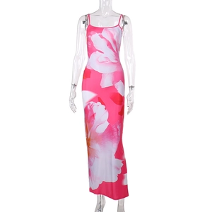 Détail d'une robe longue rose moulante avec imprimé floral blanc et fines bretelles