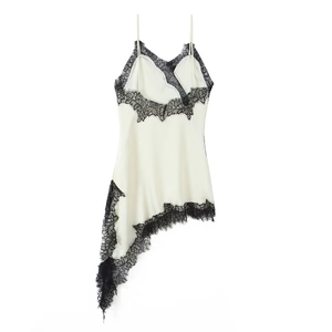 Detail of elegant lace trim and asymmetrical hemline on white satin slip dress