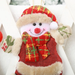 Close-up of a plush Christmas snowman ornament with red hat and checkered patterns