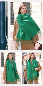 Detailed view of soft green cashmere-like scarf with fringe on European street