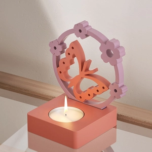 Detailed view of DIY butterfly wreath candle holder with warm tealight in a modern home setting