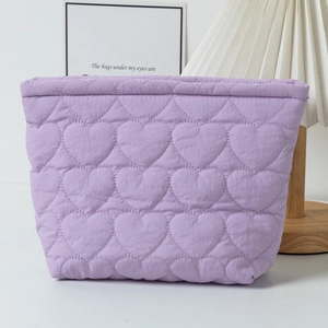 Stylish lavender quilted makeup bag featuring heart stitching pattern for cosmetics storage