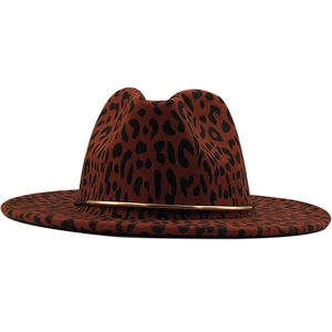Detail of leopard print fedora hat with red-brown felt and gold metal band accent