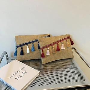 Linen envelope clutch bags with colorful tassels on a metal shelf for a natural look