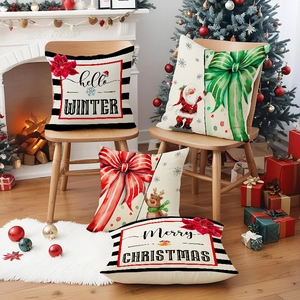 Set of four Christmas linen pillow covers featuring Santa and reindeer on a cozy sofa