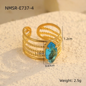 Detailed macro view of gold plated multi-layer ring with marquise cut blue zircon stone