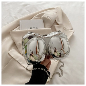 Macro shot of silver mirrored bionic shell clutch bag with detachable metal chain strap