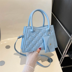 Sky blue quilted handbag with cross-body strap and matching coin purse charm
