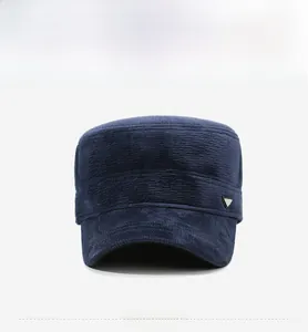Detail of dark blue corduroy cadet cap featuring a side silver triangle metal logo