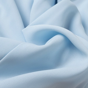 Light blue chiffon blouse fabric detail showing soft texture and fluid drape quality