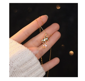 Detailed close-up of a gold S925 silver bear necklace with a colorful star pendant