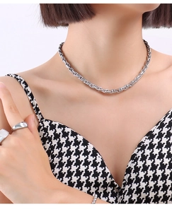 Close-up of silver thick chain necklace with industrial link design on a model