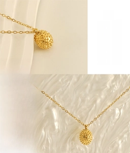 Detail of 18k gold plated stainless steel durian pendant with lead-free safety texture