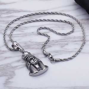 Retro stainless steel Pharaoh pendant necklace with twisted chain on marble background