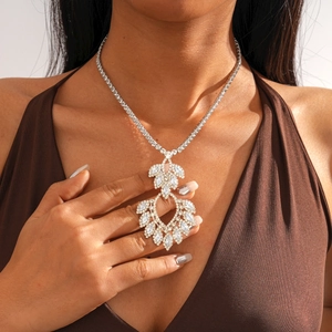 Close-up of silver-tone hollow teardrop pendant necklace with zircon and crystals