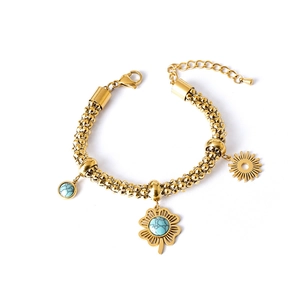 Gold-plated stainless steel bracelet with turquoise clover and sun charms on white base