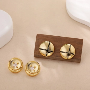 Detail of 18K gold button earrings with black zircon cross and square white stones