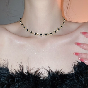 Close-up of choker necklace with blue floral gems and crystals on woman's neck
