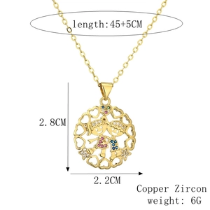 Detail of hollow round gold pendant with children icons and multicolor zircon stones
