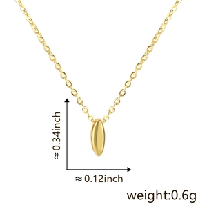 Detail view of the small rice-shaped gold letter pendant with exact size and weight specs