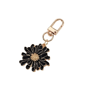 Black and gold flower keychain with daisy pendant and metallic golden key ring