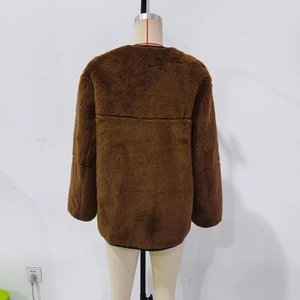 Detail view of the plush faux fur texture on the back of this dark brown winter jacket