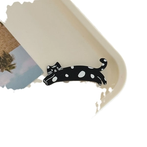 Cute black and white polka dot cat hair clip for women with a playful cartoon animal design