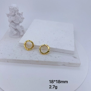 18mm gold plated circular earrings with colorful cubic zirconia on white stone background