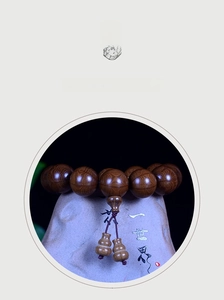 Macro detail of dark brown Liudaomu wood beads with natural grain and double gourd pendants