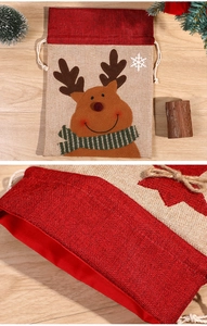 Close-up of reindeer pattern linen gift bag with durable drawstring stitching and fabric texture