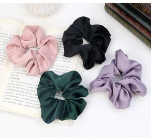 Selection of four glossy satin scrunchies in pink, black, dark green and lilac purple
