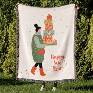 Detail of Christmas throw blanket with festive cartoon print and colorful fringe edges