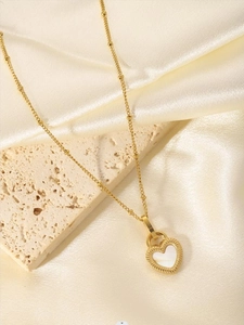 Detail of a 18K gold plated heart necklace with white shell inlay on beaded satellite chain