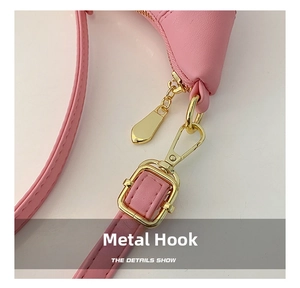 Detailed close-up of pink PU leather kids bag with gold-plated metal hook and buckle