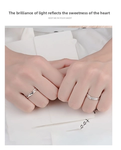 Close-up of silver Mobius couple rings with twisted design and delicate sparkling stones