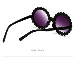 Rear view of flower-shaped children's sunglasses in black with purple gradient lenses