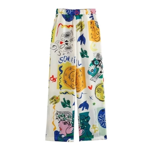 Pantalon large blanc pour femme avec graffitis pop-art et imprimés soleil vibrants