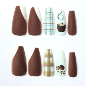 Detail of coffee brown and white matte press-on nails with plaid and coffee bean patterns