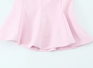 Detailed macro view of the pink ruffled hemline with neat stitching on smooth fabric