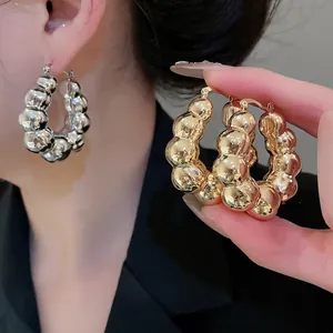 Chunky bubble textured round hoop earrings in polished gold and silver metal finishes