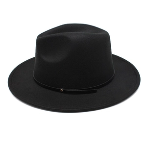 Detail of black wool fedora featuring slim leather band and golden brass buckle