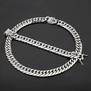 Macro detail of silver curb link chain with secure box clasp and polished finish