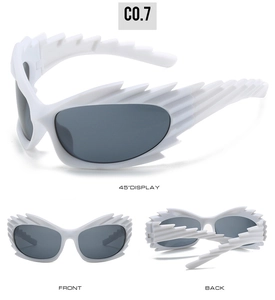 Detail view of white futuristic sunglasses with spiked frames and dark grey lenses