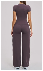 Detail of high-waist flared yoga pants and cropped top in smoky purple matte fabric