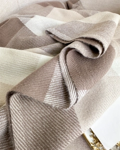 Close-up of soft beige and brown plaid scarf showing high-quality twill texture