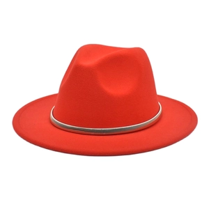 Detail of red wool felt fedora featuring a silver metallic band and classic indented crown