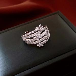 Macro shot of silver multilayer star ring with zircons on black jewelry box background