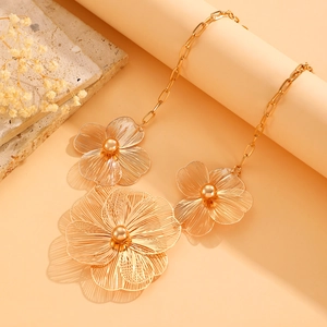 Close-up of golden hollow flower necklace pendants with elegant ring chain detail