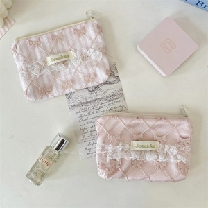 Pink quilted satin makeup bag with delicate lace trim and metal zipper detail