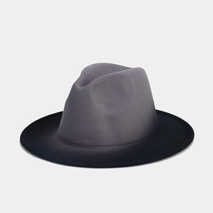 Detail of grey and black two-tone fedora hat showing felt texture and classic crease
